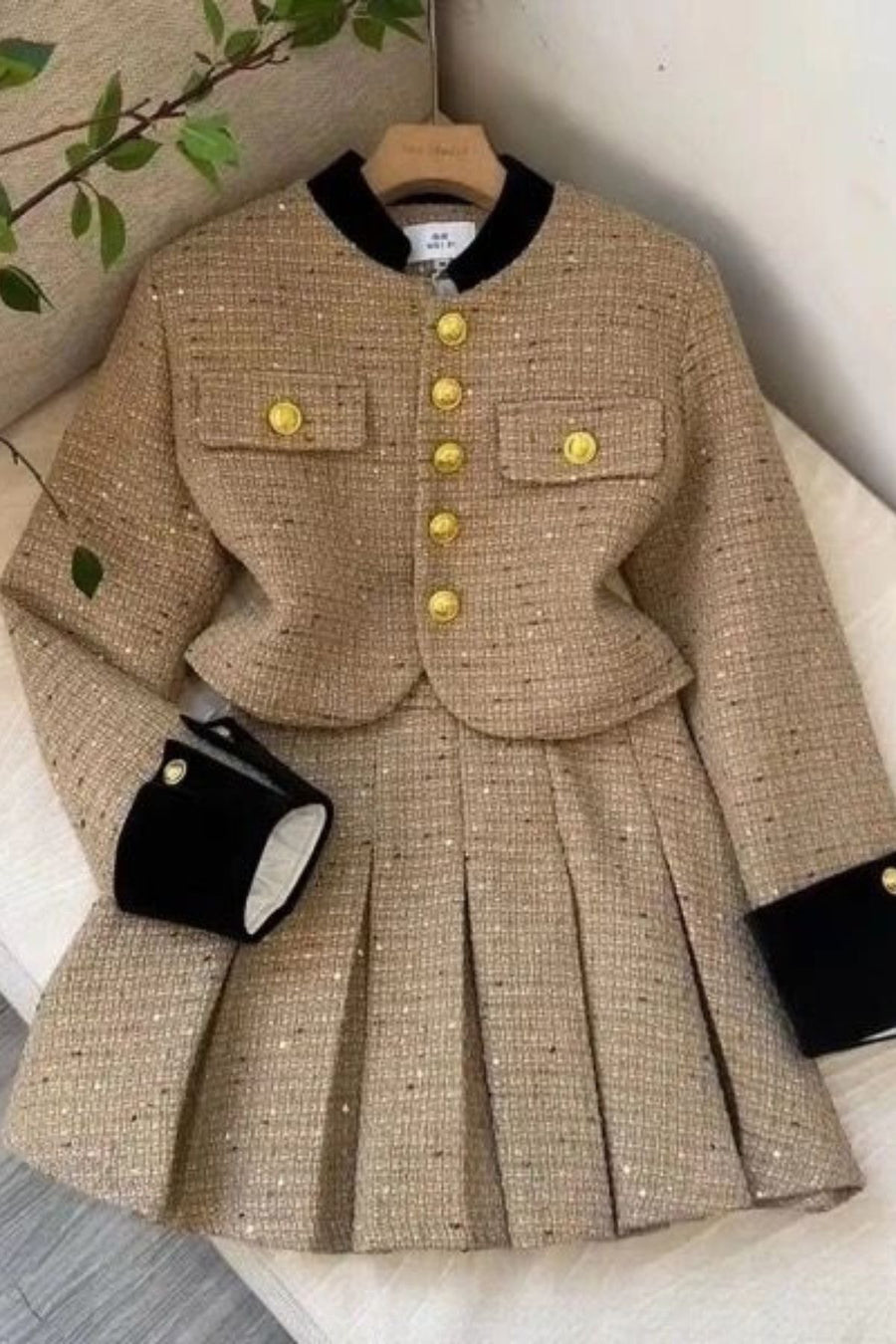 Two-piece tweed blouse and skirt set.