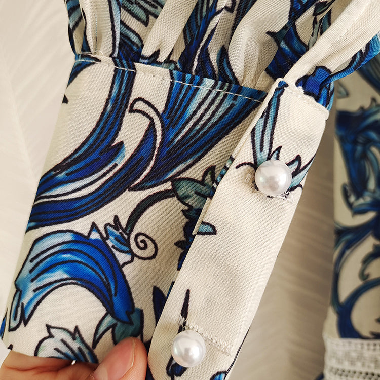 Midi dress with lantern sleeves and pearl buttons with high quality blue floral print