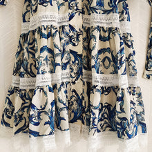 Midi dress with lantern sleeves and pearl buttons with high quality blue floral print