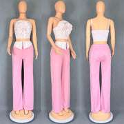 Short two-piece set with striped straps and floral appliqués, wide-legged pants