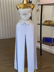 Short two-piece set with striped straps and floral appliqués, wide-legged pants