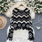 Elegant knitted blouse with tassels and long sleeves with a round neck and openings with flowers and hooks