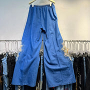 Casual two-piece set: heavy floral denim shirt, loose lapel beaded top, and wide-leg jeans