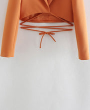 Set of short orange jacket with hem and collar, elegant shorts