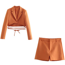 Set of short orange jacket with hem and collar, elegant shorts
