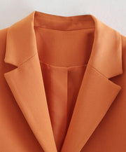 Set of short orange jacket with hem and collar, elegant shorts