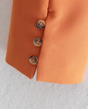 Set of short orange jacket with hem and collar, elegant shorts