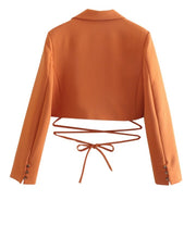 Set of short orange jacket with hem and collar, elegant shorts